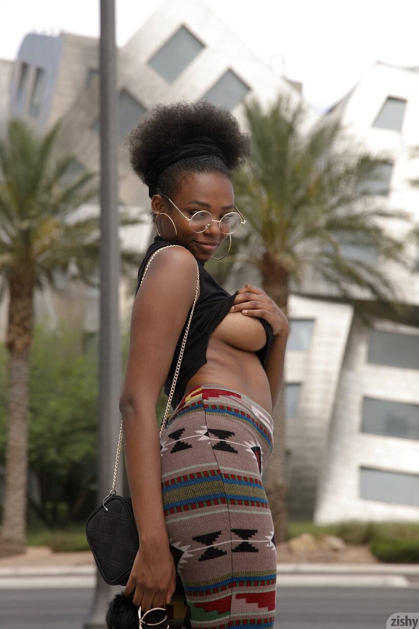 Image 2/12: Clothed Neda Marie in glasses shows her ass outdoors